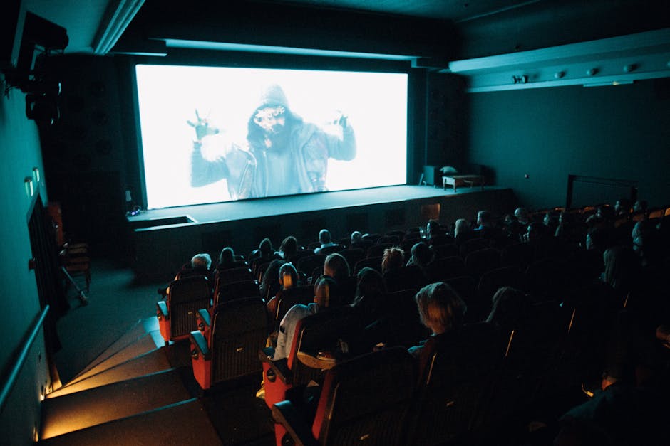 Audience watching a film in a dark cinema theater