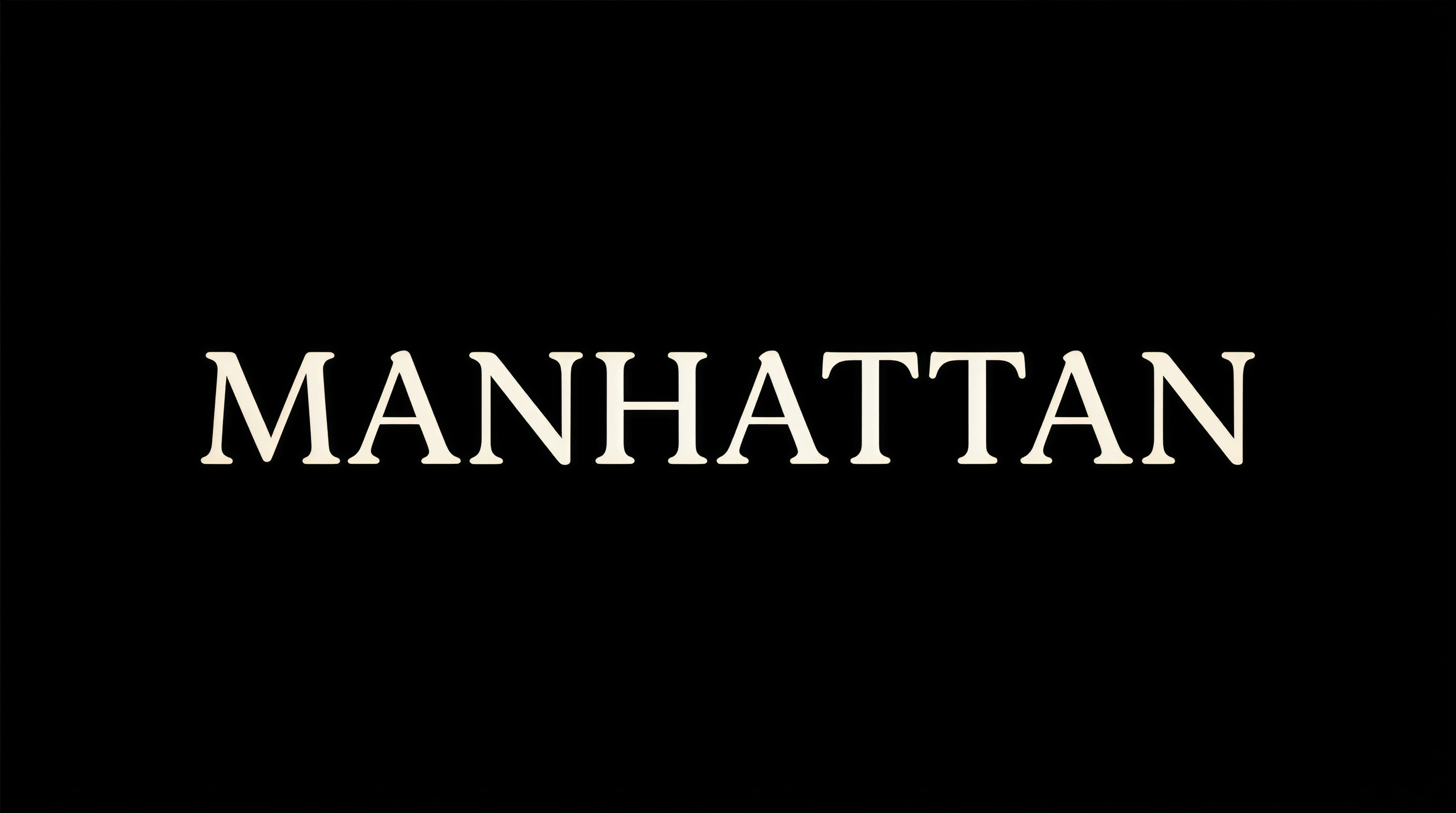 Windsor-style title card showing MANHATTAN in warm serif typography on black background