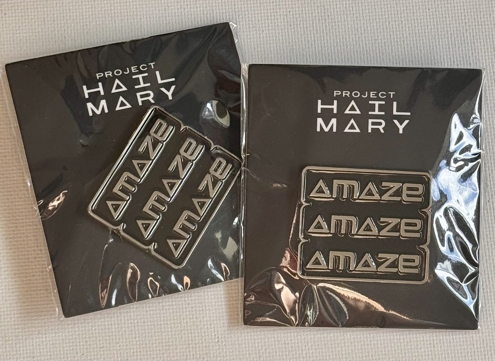Project Hail Mary IMAX release pins featuring the Cindie Mono C typeface and AMAZE AMAZE AMAZE branding