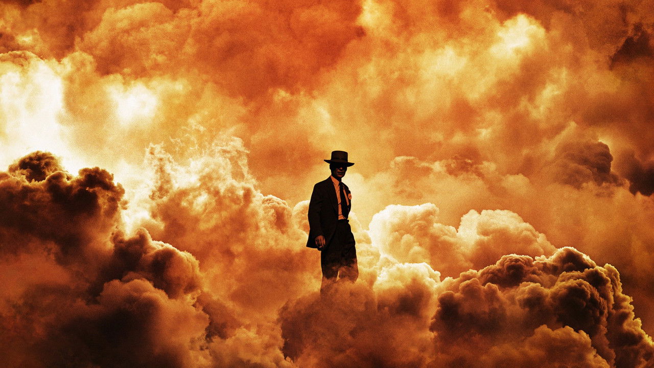 Cillian Murphy as J. Robert Oppenheimer silhouetted against a massive fiery explosion