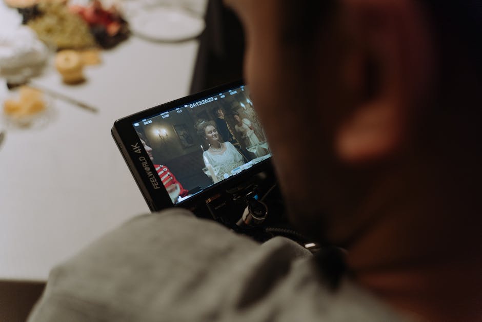 Filmmaker reviewing a live scene on a field monitor during a film shoot