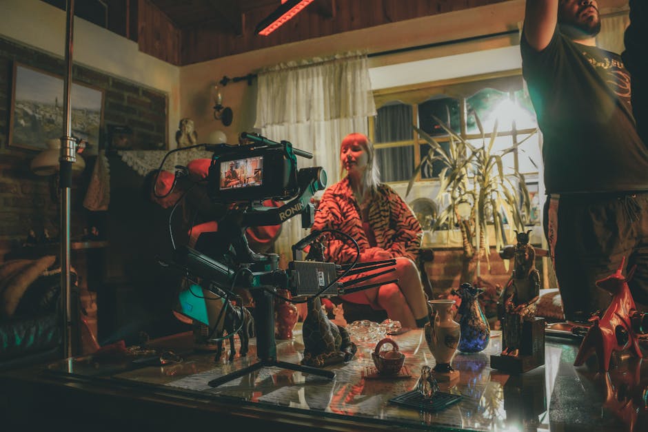 A film set dressed with props and decorative objects — camera and crew visible in a richly decorated interior location